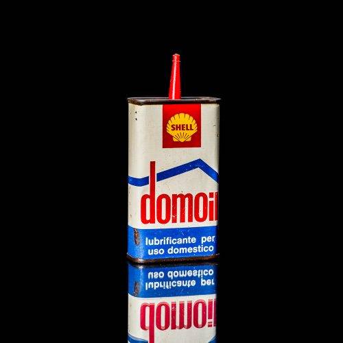 Rare and unique vintage mini Shell oil can Handy oil from 1900–1950 with red and yellow accents, featuring the classic Shell logo. This small antique tin is displayed in a studio setting against a solid black background." Handy oil cans