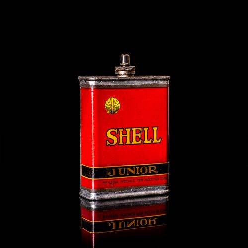 Vintage Shell oil cans with red and yellow branding from the 1900-1920 old logo Vintage Shell oil cans from 1900-19255, featuring the old logo. The photo showcases an antique tin red with yellow accents, displaying the historic Shell emblem. Shot in a studio against a solid black background