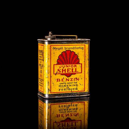 Vintage Shell oil cans with red and yellow branding from the 1900-1920 old logo Vintage Shell oil cans from 1900-19255, featuring the old logo. The photo showcases an antique tin red with yellow accents, displaying the historic Shell emblem. Shot in a studio against a solid black background