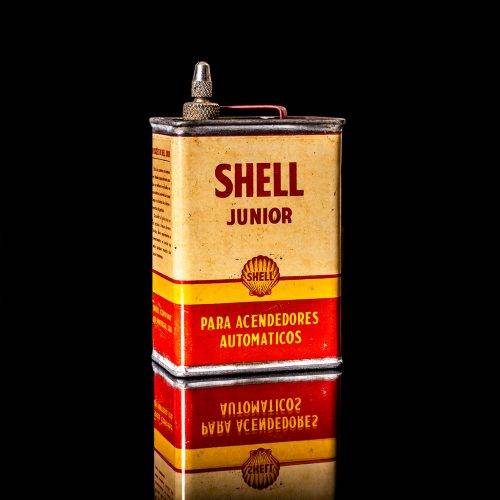 Vintage Shell oil cans with red and yellow branding from the 1900-1920 old logo Vintage Shell oil cans from 1900-19255, featuring the old logo. The photo showcases an antique tin red with yellow accents, displaying the historic Shell emblem. Shot in a studio against a solid black background