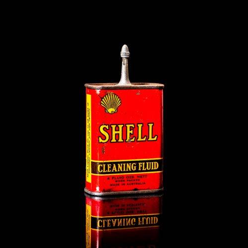 Vintage Shell oil cans with red and yellow branding from the 1900-1920 old logo Vintage Shell oil cans from 1900-19255, featuring the old logo. The photo showcases an antique tin red with yellow accents, displaying the historic Shell emblem. Shot in a studio against a solid black background
