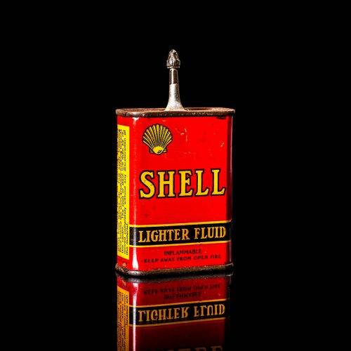 Vintage Shell oil cans with red and yellow branding from the 1900-1920 old logo Vintage Shell oil cans from 1900-19255, featuring the old logo. The photo showcases an antique tin red with yellow accents, displaying the historic Shell emblem. Shot in a studio against a solid black background