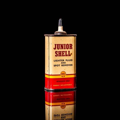Vintage Shell oil cans with red and yellow branding from the 1900-1920 old logo Vintage Shell oil cans from 1900-19255, featuring the old logo. The photo showcases an antique tin red with yellow accents, displaying the historic Shell emblem. Shot in a studio against a solid black background
