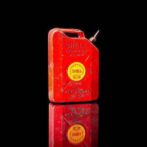 Vintage Shell oil cans with red and yellow branding from the 1900-1920 old logo Vintage Shell oil cans from 1900-19255, featuring the old logo. The photo showcases an antique tin red with yellow accents, displaying the historic Shell emblem. Shot in a studio against a solid black background