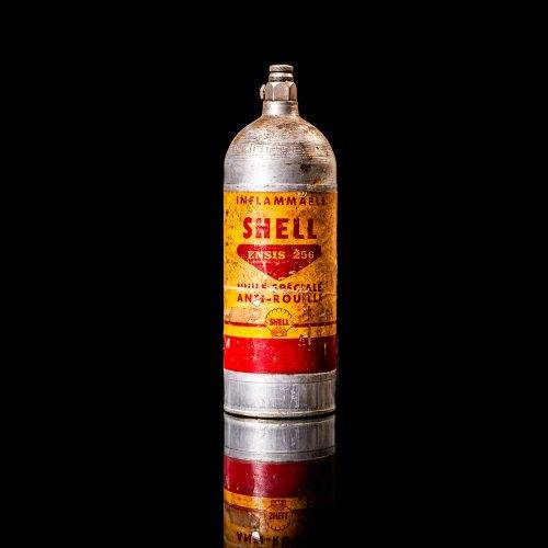 Rare and unique vintage mini Shell oil can from 1900–1950 with red and yellow accents, featuring the classic Shell logo. This small antique tin is displayed in a studio setting against a solid black background." lighter fluid shell cans