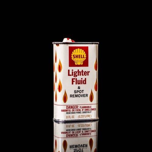 Vintage Shell oil cans with red and yellow branding from the 1900-1920 old logo Vintage Shell oil cans from 1900-19255, featuring the old logo. The photo showcases an antique tin red with yellow accents, displaying the historic Shell emblem. Shot in a studio against a solid black background