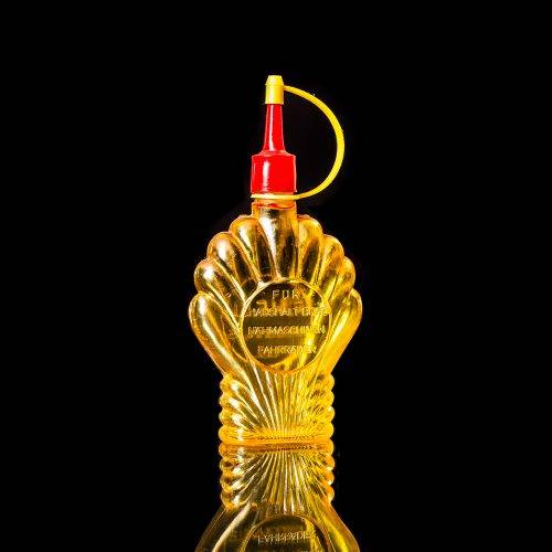 Vintage Shell oil cans with red and yellow branding from the 1900-1920 old logo Vintage Shell oil cans from 1900-19255, featuring the old logo. The photo showcases an antique tin red with yellow accents, displaying the historic Shell emblem. Shot in a studio against a solid black background
