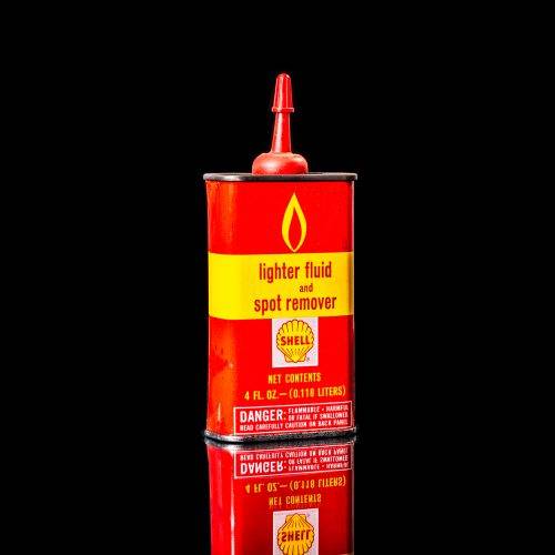 Rare and unique vintage mini Shell oil can from 1900–1950 with red and yellow accents, featuring the classic Shell logo. This small antique tin is displayed in a studio setting against a solid black background." lighter fluid shell cans