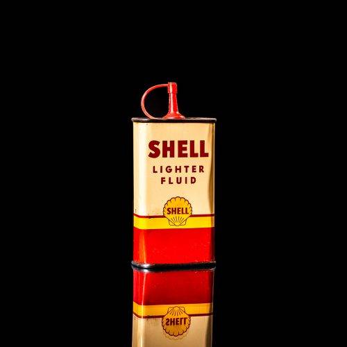 Vintage Shell oil cans with red and yellow branding from the 1900-1920 old logo Vintage Shell oil cans from 1900-19255, featuring the old logo. The photo showcases an antique tin red with yellow accents, displaying the historic Shell emblem. Shot in a studio against a solid black background