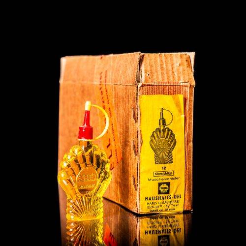 Rare and unique vintage mini Shell oil can from 1900–1950 with red and yellow accents, featuring the classic Shell logo. This small antique tin is displayed in a studio setting against a solid black background." lighter fluid shell cans