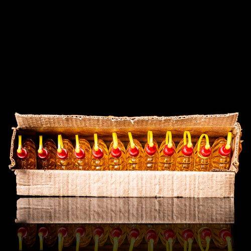 Rare and unique vintage mini Shell oil can from 1900–1950 with red and yellow accents, featuring the classic Shell logo. This small antique tin is displayed in a studio setting against a solid black background." lighter fluid shell cans