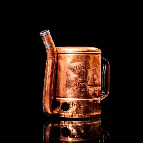 Rare and unique vintage Shell oil pourer from 1900–1950 with red and yellow accents, featuring the classic Shell logo. This antique metal spout can is displayed in a studio setting against a solid black background.