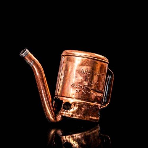 Vintage Shell oil cans with red and yellow branding from the 1900-1920 old logo Vintage Shell oil cans from 1900-19255, featuring the old logo. The photo showcases an antique tin red with yellow accents, displaying the historic Shell emblem. Shot in a studio against a solid black background