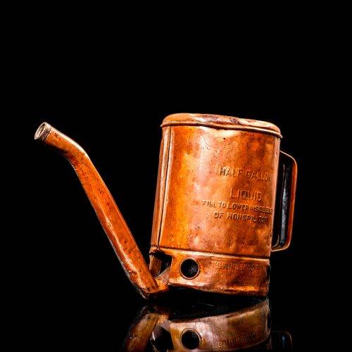 Vintage Shell oil cans with red and yellow branding from the 1900-1920 old logo Vintage Shell oil cans from 1900-19255, featuring the old logo. The photo showcases an antique tin red with yellow accents, displaying the historic Shell emblem. Shot in a studio against a solid black background