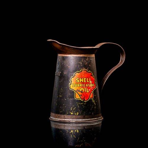 Rare and unique vintage Shell oil pourer from 1900–1950 with red and yellow accents, featuring the classic Shell logo. This antique metal spout can is displayed in a studio setting against a solid black background.