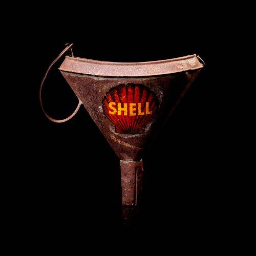 Vintage Shell oil cans with red and yellow branding from the 1900-1920 old logo Vintage Shell oil cans from 1900-19255, featuring the old logo. The photo showcases an antique tin red with yellow accents, displaying the historic Shell emblem. Shot in a studio against a solid black background