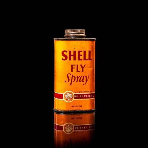 Vintage Shell oil cans with red and yellow branding from the 1900-1920 old logo Vintage Shell oil cans from 1900-19255, featuring the old logo. The photo showcases an antique tin red with yellow accents, displaying the historic Shell emblem. Shot in a studio against a solid black background
