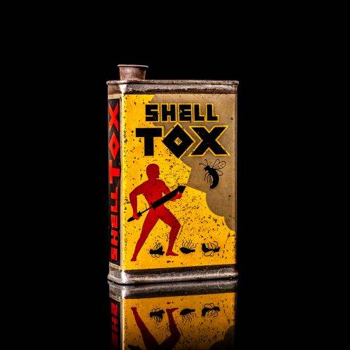 Rare and unique vintage Shell DDT can from 1900–1950, featuring bold red and yellow Shelltox branding and the classic Shell logo. This antique pesticide tin is displayed in a studio setting against a solid black background.