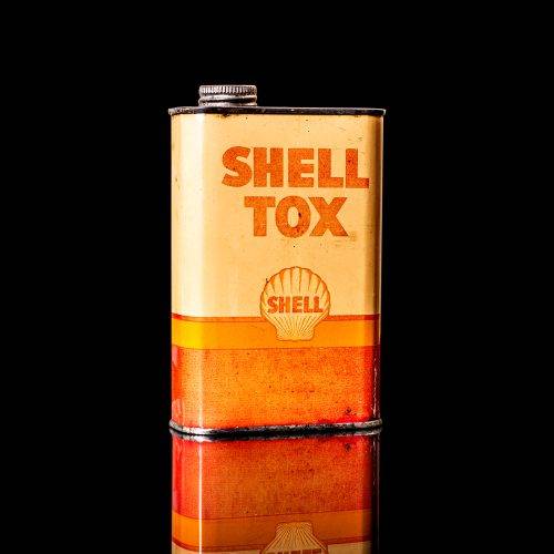Vintage Shell oil cans with red and yellow branding from the 1900-1920 old logo Vintage Shell oil cans from 1900-19255, featuring the old logo. The photo showcases an antique tin red with yellow accents, displaying the historic Shell emblem. Shot in a studio against a solid black background