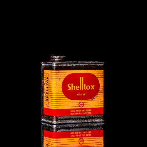 Vintage Shell oil cans with red and yellow branding from the 1900-1920 old logo Vintage Shell oil cans from 1900-19255, featuring the old logo. The photo showcases an antique tin red with yellow accents, displaying the historic Shell emblem. Shot in a studio against a solid black background