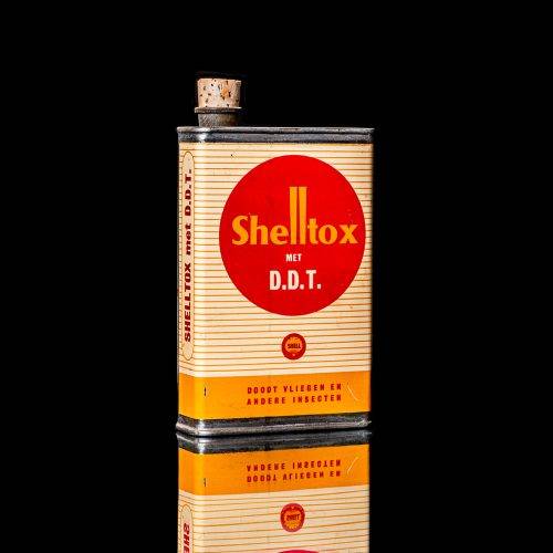 Rare and unique vintage Shell DDT can from 1900–1950, featuring bold red and yellow Shelltox branding and the classic Shell logo. This antique pesticide tin is displayed in a studio setting against a solid black background.