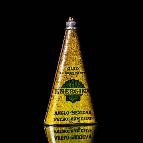 Extremely rare and unique vintage Shell triangular oil can from 1900–1950, featuring red and yellow accents and the classic Shell logo, including a rare shell branding. This antique three-sided tin is displayed in a studio setting against a solid black background.