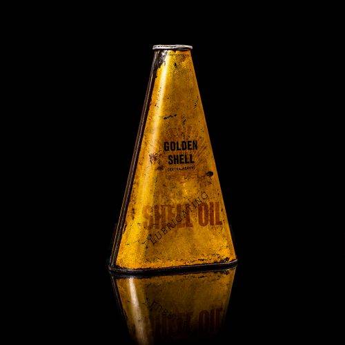 Vintage Shell oil cans with red and yellow branding from the 1900-1920 old logo Vintage Shell oil cans from 1900-19255, featuring the old logo. The photo showcases an antique tin red with yellow accents, displaying the historic Shell emblem. Shot in a studio against a solid black background