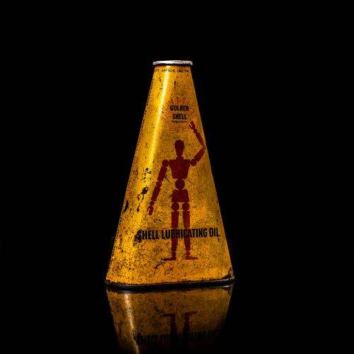 Extremely rare and unique vintage Shell triangular oil can from 1900–1950, featuring red and yellow accents and the classic Shell logo, including a rare shell branding. This antique three-sided tin is displayed in a studio setting against a solid black background.