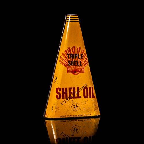 Vintage Shell oil cans with red and yellow branding from the 1900-1920 old logo Vintage Shell oil cans from 1900-19255, featuring the old logo. The photo showcases an antique tin red with yellow accents, displaying the historic Shell emblem. Shot in a studio against a solid black background