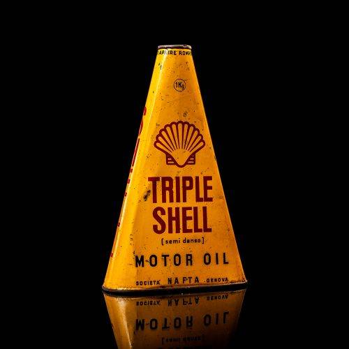 Extremely rare and unique vintage Shell triangular oil can from 1900–1950, featuring red and yellow accents and the classic Shell logo, including a rare shell branding. This antique three-sided tin is displayed in a studio setting against a solid black background.