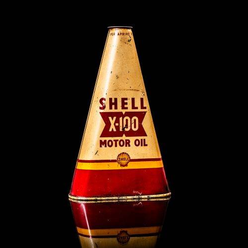 Vintage Shell oil cans with red and yellow branding from the 1900-1920 old logo Vintage Shell oil cans from 1900-19255, featuring the old logo. The photo showcases an antique tin red with yellow accents, displaying the historic Shell emblem. Shot in a studio against a solid black background