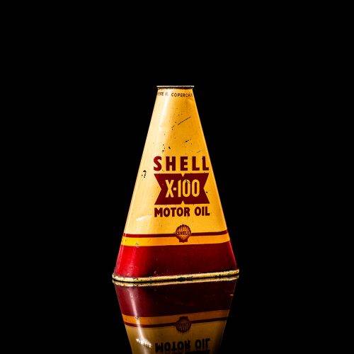Vintage Shell oil cans with red and yellow branding from the 1900-1920 old logo Vintage Shell oil cans from 1900-19255, featuring the old logo. The photo showcases an antique tin red with yellow accents, displaying the historic Shell emblem. Shot in a studio against a solid black background
