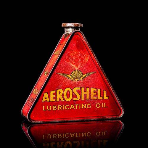 Extremely rare and unique vintage Shell triangular oil can from 1900–1950, featuring red and yellow accents and the classic Shell logo, including a rare shell branding. This antique three-sided tin is displayed in a studio setting against a solid black background.