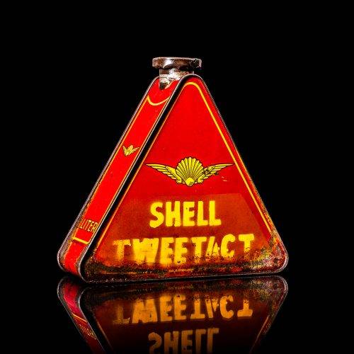 Extremely rare and unique vintage Shell triangular oil can from 1900–1950, featuring red and yellow accents and the classic Shell logo, including a rare shell branding. This antique three-sided tin is displayed in a studio setting against a solid black background.
