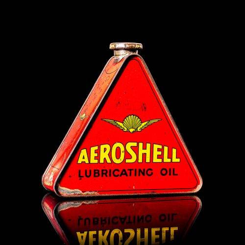 Extremely rare and unique vintage Shell triangular oil can from 1900–1950, featuring red and yellow accents and the classic Shell logo, including a rare shell branding. This antique three-sided tin is displayed in a studio setting against a solid black background.