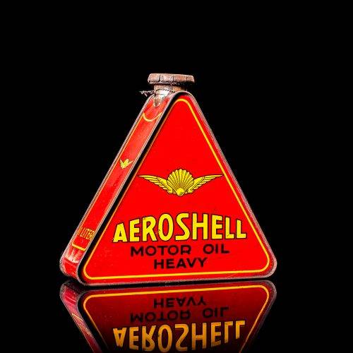 Extremely rare and unique vintage Shell triangular oil can from 1900–1950, featuring red and yellow accents and the classic Shell logo, including a rare shell branding. This antique three-sided tin is displayed in a studio setting against a solid black background.