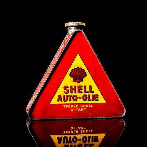 Extremely rare and unique vintage Shell triangular oil can from 1900–1950, featuring red and yellow accents and the classic Shell logo, including a rare shell branding. This antique three-sided tin is displayed in a studio setting against a solid black background.