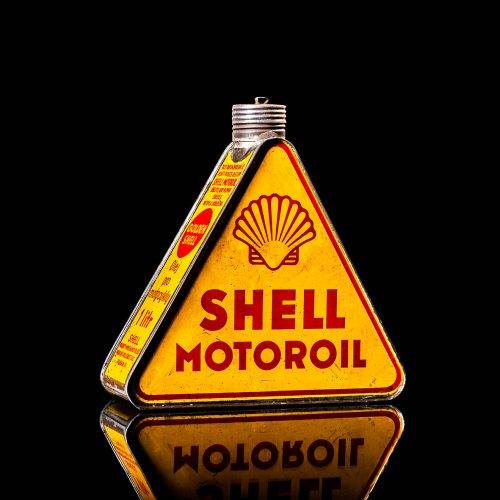 Vintage Shell oil cans with red and yellow branding from the 1900-1920 old logo Vintage Shell oil cans from 1900-19255, featuring the old logo. The photo showcases an antique tin red with yellow accents, displaying the historic Shell emblem. Shot in a studio against a solid black background