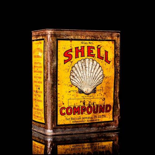 Vintage Shell oil cans with red and yellow branding from the 1900-1920 old logo Vintage Shell oil cans from 1900-1920, featuring the old logo. The photo showcases an antique tin red with yellow accents, displaying the historic Shell emblem. Shot in a studio against a solid black background