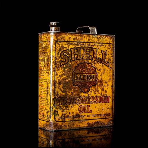 Vintage Shell oil cans with red and yellow branding from the 1920-1940 old logo Vintage Shell oil cans from 1900-1920, featuring the old logo. The photo showcases an antique tin yellow with red accenaccents, displaying the historic Shell emblem. Shot in a studio against a solid black background