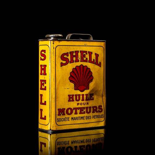 Vintage Shell oil cans with red and yellow branding from the 1920-1940 old logo Vintage Shell oil cans from 1900-1920, featuring the old logo. The photo showcases an antique tin yellow with red accenaccents, displaying the historic Shell emblem. Shot in a studio against a solid black background