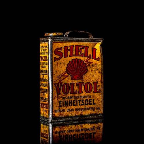 Vintage Shell oil cans with red and yellow branding from the 1920-1940 old logo Vintage Shell oil cans from 1900-1920, featuring the old logo. The photo showcases an antique tin yellow with red accenaccents, displaying the historic Shell emblem. Shot in a studio against a solid black background