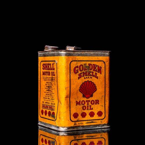 Vintage Shell oil cans with red and yellow branding from the 1920-1940 old logo Vintage Shell oil cans from 1900-1920, featuring the old logo. The photo showcases an antique tin yellow with red accenaccents, displaying the historic Shell emblem. Shot in a studio against a solid black background