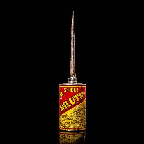 Vintage Shell oil cans with red and yellow branding from the 1920-1940 old logo Vintage Shell oil cans from 1900-1920, featuring the old logo. The photo showcases an antique tin yellow with red accenaccents, displaying the historic Shell emblem. Shot in a studio against a solid black background