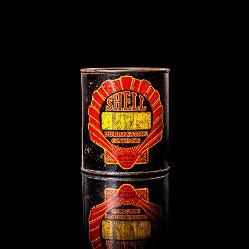 Vintage Shell oil cans with red and yellow branding from the 1920-1940 old logo Vintage Shell oil cans from 1900-1920, featuring the old logo. The photo showcases an antique tin yellow with red accenaccents, displaying the historic Shell emblem. Shot in a studio against a solid black background