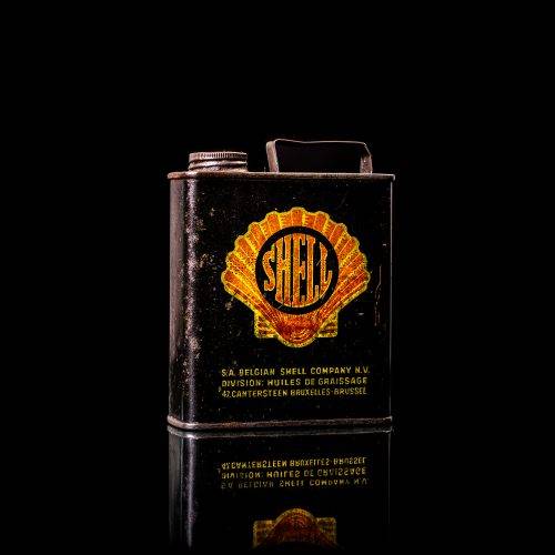 Vintage Shell oil cans with red and yellow branding from the 1920-1940 old logo Vintage Shell oil cans from 1900-1920, featuring the old logo. The photo showcases an antique tin yellow with red accenaccents, displaying the historic Shell emblem. Shot in a studio against a solid black background