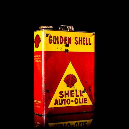 Vintage Shell oil cans with red and yellow branding from the 1920-1940 old logo Vintage Shell oil cans from 1900-1920, featuring the old logo. The photo showcases an antique tin yellow with red accenaccents, displaying the historic Shell emblem. Shot in a studio against a solid black background