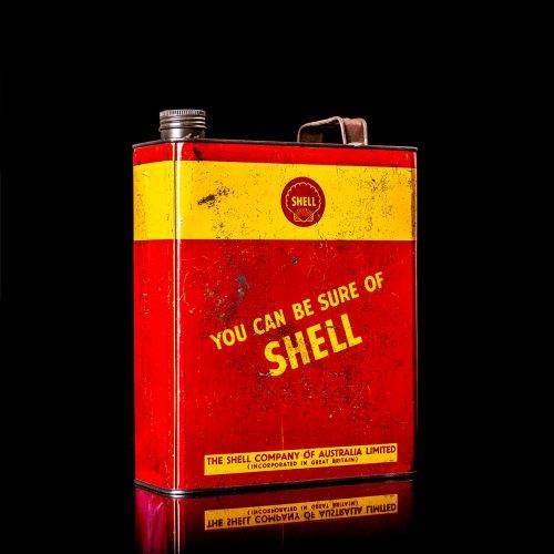 Vintage Shell oil cans with red and yellow branding from the 1920-1940 old logo Vintage Shell oil cans from 1900-1920, featuring the old logo. The photo showcases an antique tin yellow with red accenaccents, displaying the historic Shell emblem. Shot in a studio against a solid black background